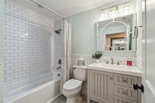 full bathroom with shower / bath combo, tile patterned flooring, vanity, a textured ceiling, and toilet