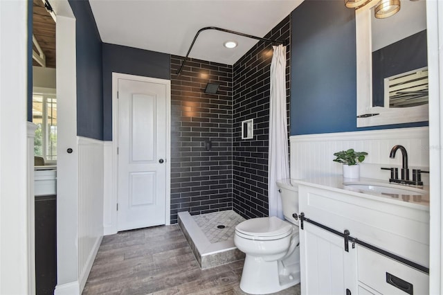 bathroom featuring hardwood / wood-style floors, vanity, curtained shower, and toilet