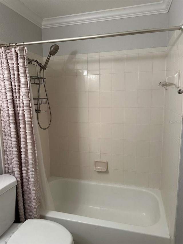 bathroom featuring shower / bath combination with curtain, ornamental molding, and toilet