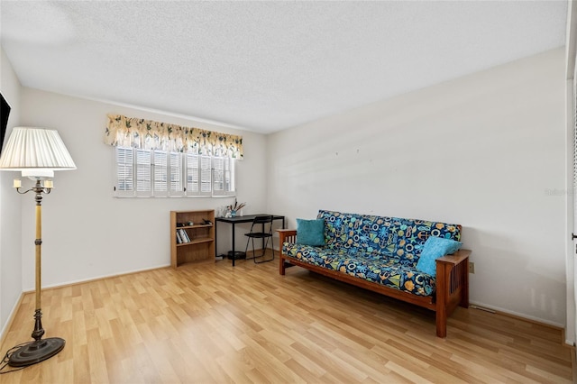 sitting room featuring hardwood / wood-style floors and a textured ceiling