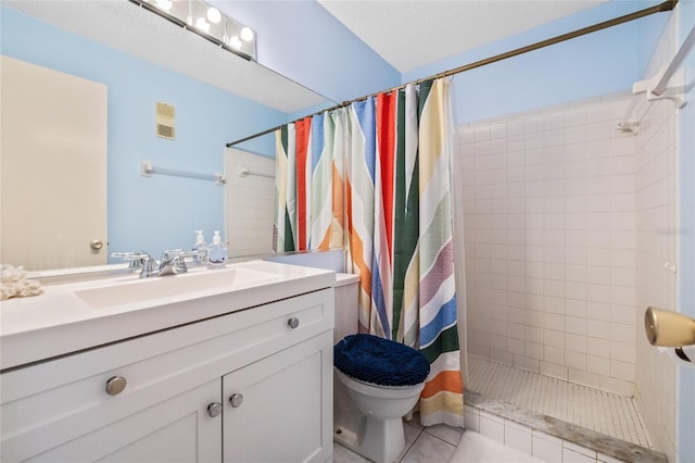 bathroom with tile patterned flooring, vanity, a textured ceiling, and walk in shower