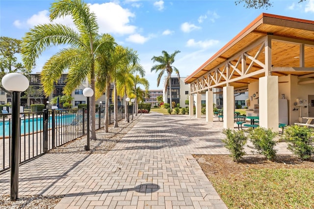 view of property's community featuring a patio and a swimming pool