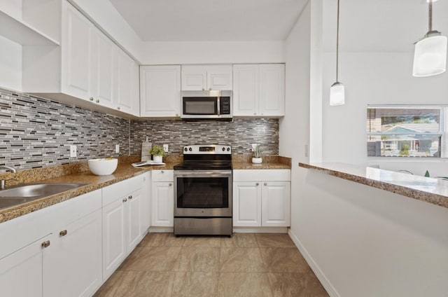 kitchen featuring decorative light fixtures, white cabinetry, stainless steel appliances, and tasteful backsplash