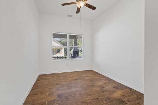 unfurnished room featuring dark wood-type flooring and ceiling fan