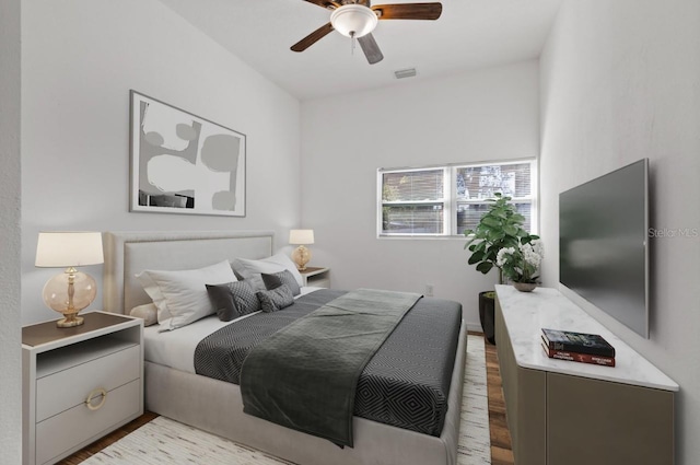 bedroom with ceiling fan and light wood-type flooring