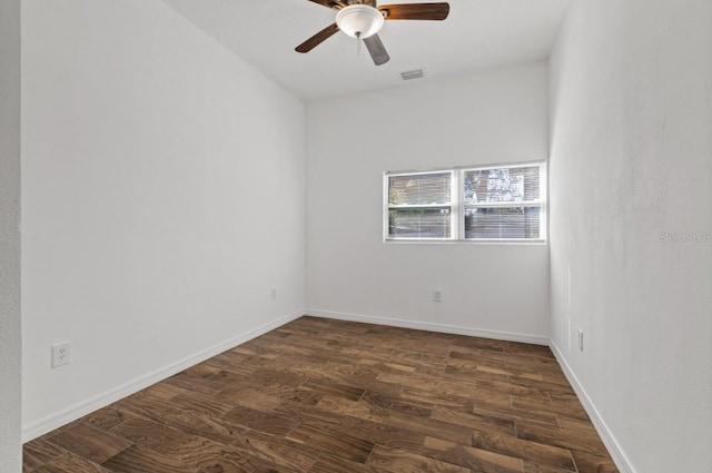 spare room with dark wood-type flooring and ceiling fan