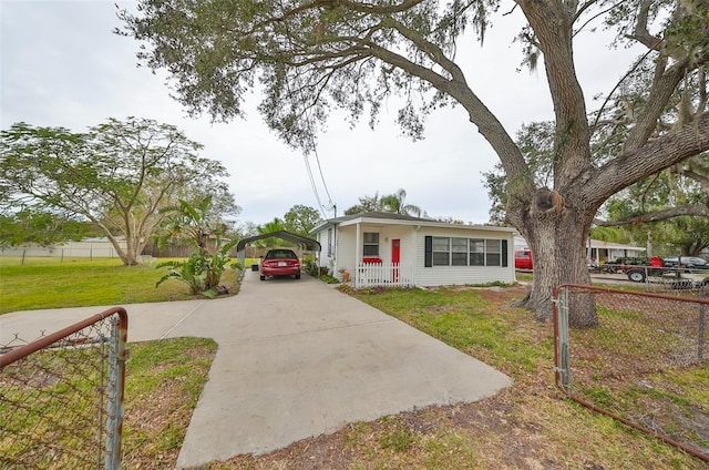 view of front facade with a front lawn and a carport