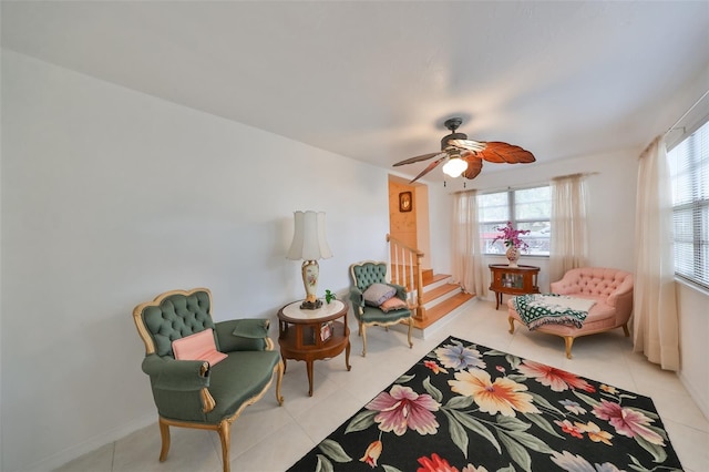 living area with light tile patterned flooring and ceiling fan