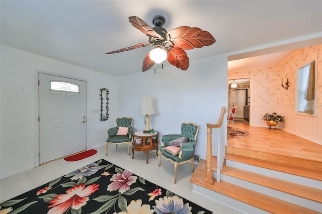 foyer entrance featuring tile patterned floors and ceiling fan