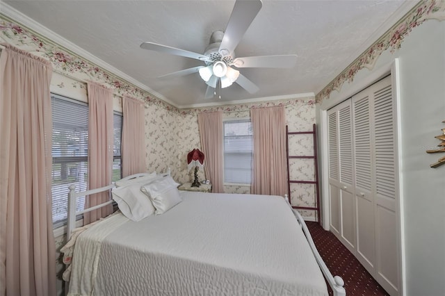 bedroom with crown molding, ceiling fan, a closet, and a textured ceiling