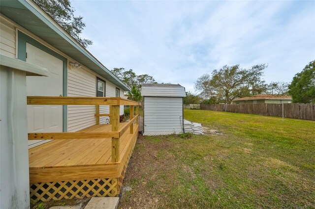 view of yard with a shed and a wooden deck