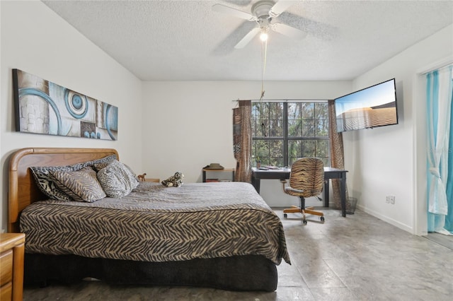 bedroom with ceiling fan and a textured ceiling