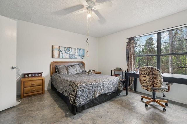 bedroom featuring ceiling fan and a textured ceiling