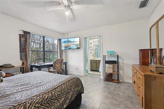 bedroom with ceiling fan, a textured ceiling, and ensuite bath