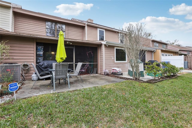 rear view of house with a yard, a patio area, and central air condition unit