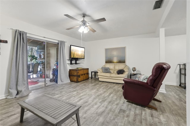 living room featuring ceiling fan and light hardwood / wood-style flooring