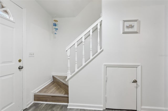 stairs with hardwood / wood-style floors