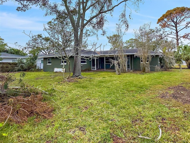 5225 Venetian Blvd NE, Saint Petersburg, FL 33703 - rear view of property with a yard