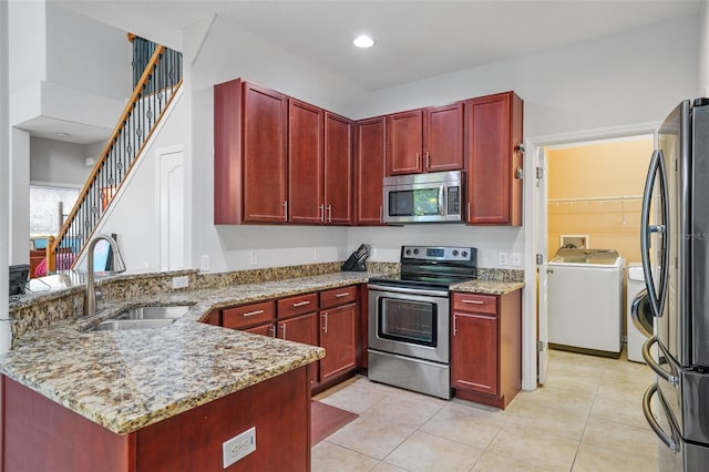 kitchen with sink, light tile patterned floors, appliances with stainless steel finishes, kitchen peninsula, and light stone countertops