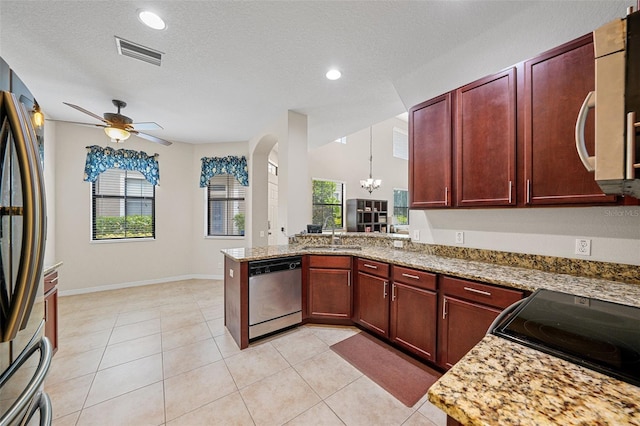 kitchen featuring pendant lighting, refrigerator, dishwasher, sink, and kitchen peninsula