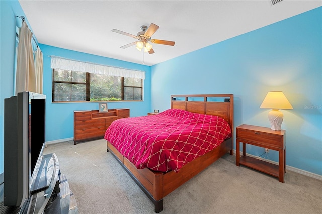 bedroom featuring light colored carpet and ceiling fan