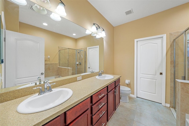 bathroom with tile patterned flooring, vanity, toilet, and walk in shower