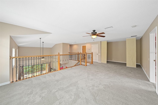 unfurnished room with lofted ceiling, carpet floors, and ceiling fan