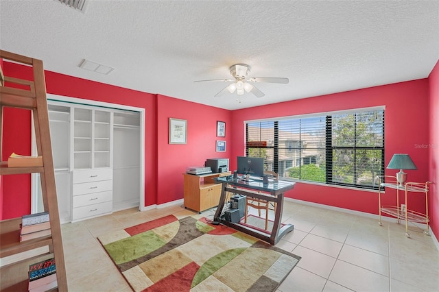 office featuring light tile patterned floors, a textured ceiling, and ceiling fan