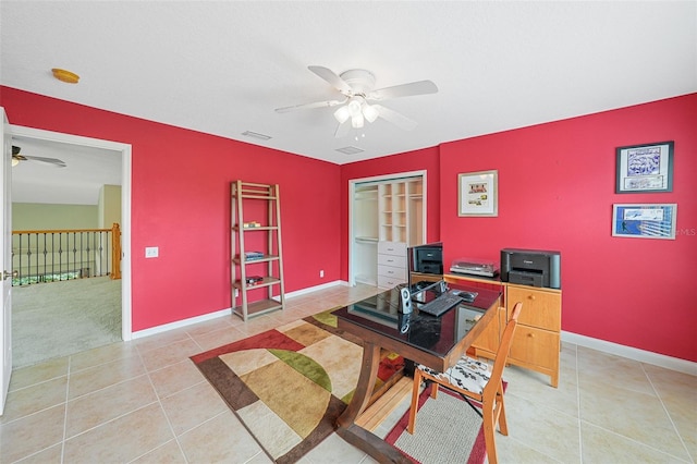 tiled home office featuring ceiling fan