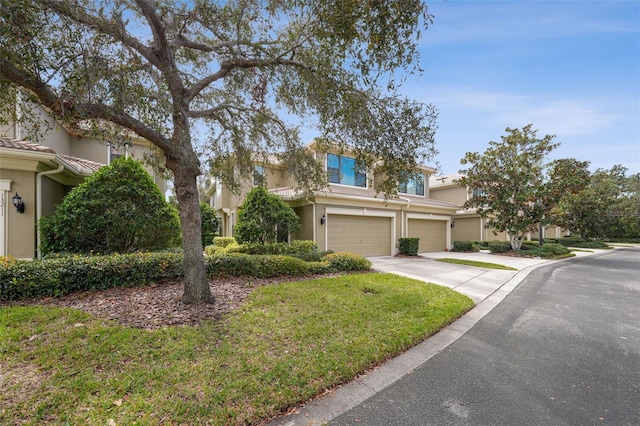 view of front of home with a garage and a front lawn