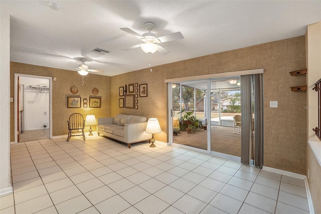 unfurnished living room with light tile patterned floors and ceiling fan