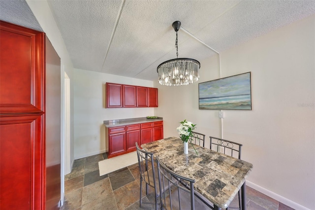 dining room featuring an inviting chandelier and a textured ceiling