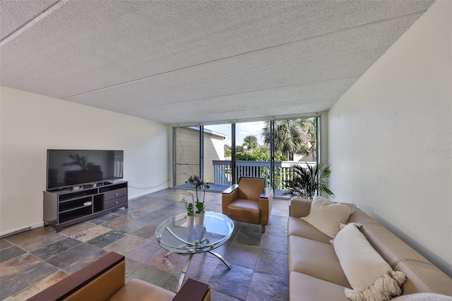 living room featuring a wall of windows and a textured ceiling