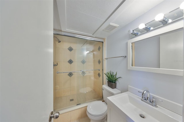 bathroom with vanity, an enclosed shower, and toilet