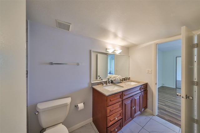 bathroom with vanity and toilet