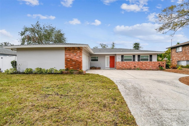 ranch-style home with a garage and a front lawn