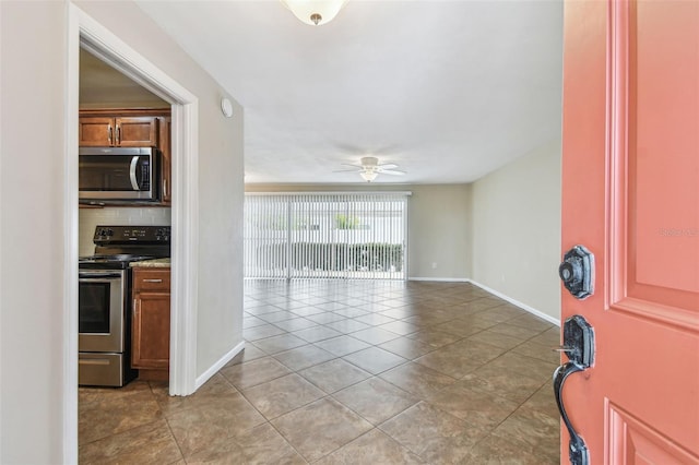 tiled foyer entrance featuring ceiling fan