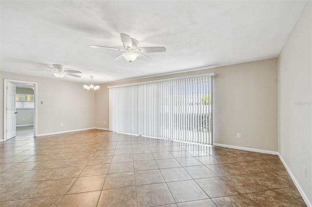 tiled empty room featuring ceiling fan with notable chandelier