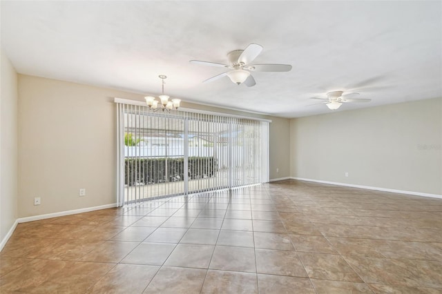 spare room featuring light tile patterned flooring and ceiling fan with notable chandelier