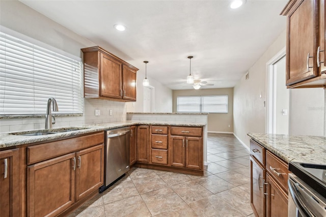 kitchen with kitchen peninsula, ceiling fan, stainless steel appliances, hanging light fixtures, and sink