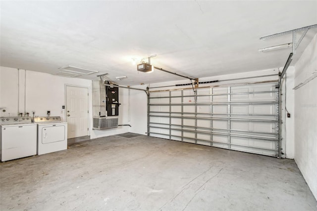 garage with heating unit, independent washer and dryer, and a garage door opener