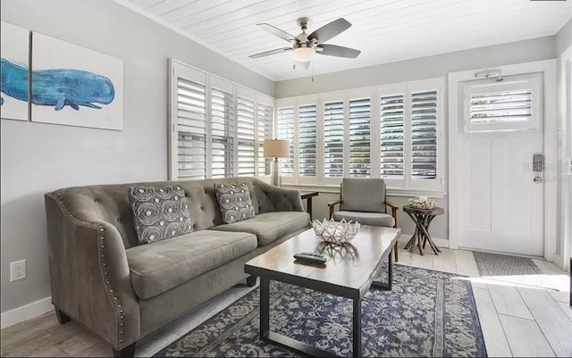 living room with ceiling fan and light hardwood / wood-style flooring