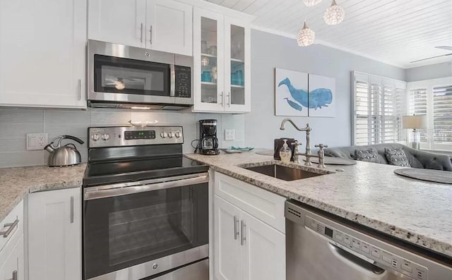 kitchen featuring appliances with stainless steel finishes, white cabinetry, and sink