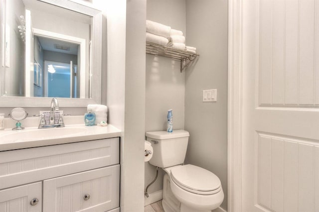 bathroom featuring toilet and vanity