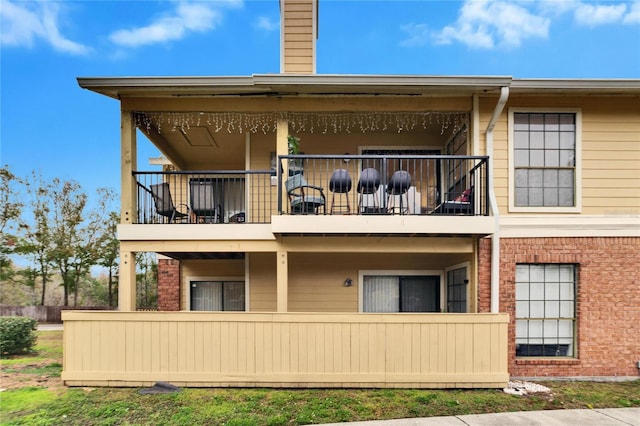 back of property with a balcony