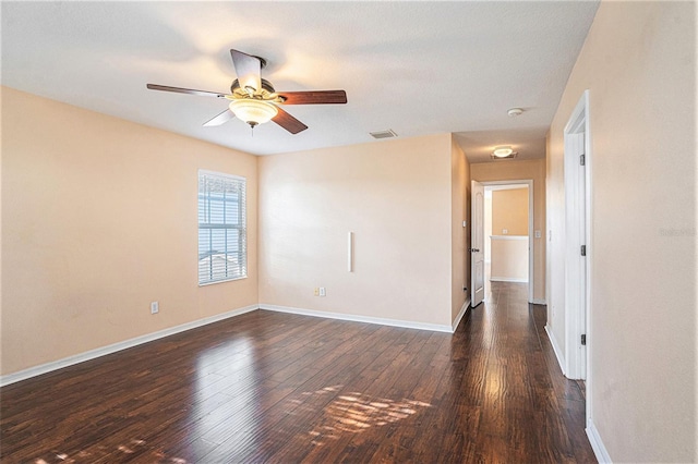 unfurnished room with dark hardwood / wood-style flooring and ceiling fan