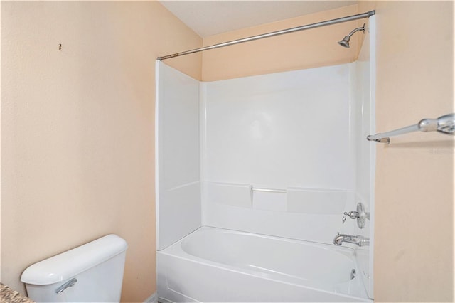 bathroom with shower / washtub combination and toilet