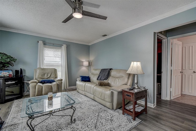 living room with a textured ceiling, crown molding, and hardwood / wood-style floors