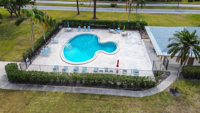 view of swimming pool with a patio area and a lawn