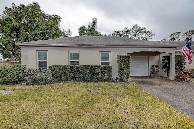 ranch-style home with a front yard, a carport, and a garage